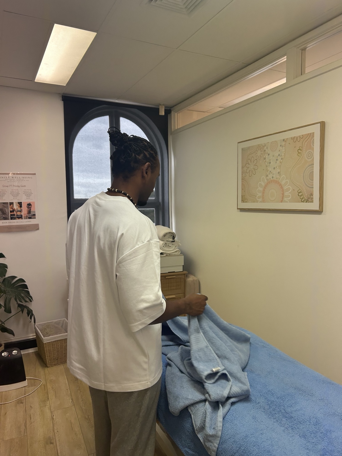 Denis preparing a professional massage treatment room